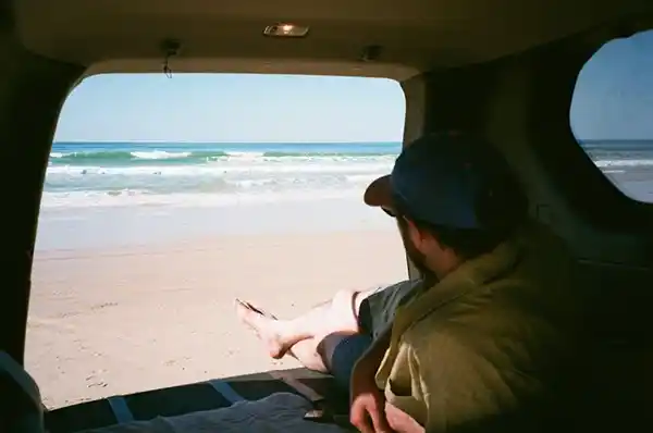 A car on a Queensland coastal highway during a road trip
