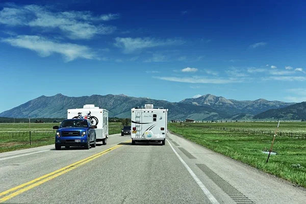 An RV parked on a scenic road during a long travel trip