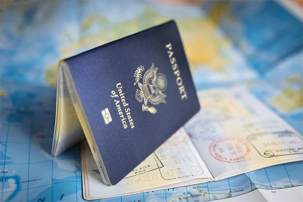 A passport and boarding pass resting on a world map
