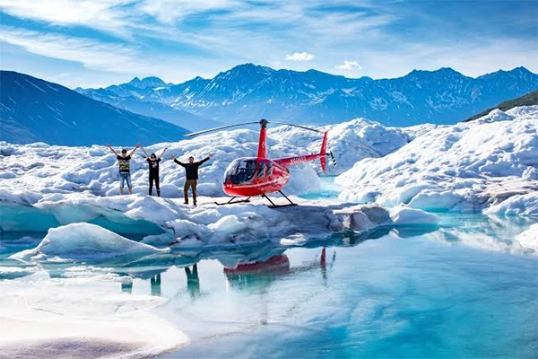 Travellers enjoying a glacier on an Alaska helicopter tour